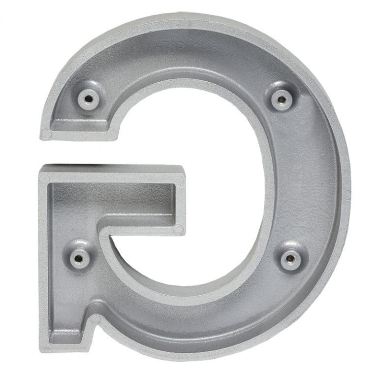 A photograph of the reverse side of the letter "G" cast in aluminum